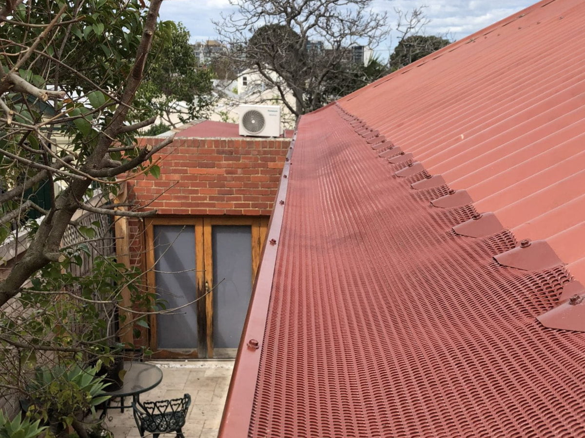 A Leafbusters gutter guard on a corrugated roof
