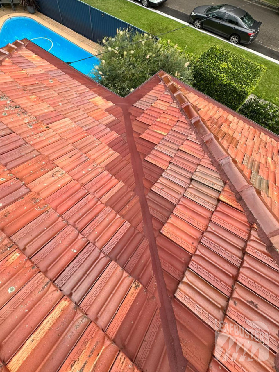 Leafbusters valley guard installed on a red tile roof